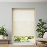 Main view of off-white Ivory signature light filtering roller shades in a bright living room with indoor plants.