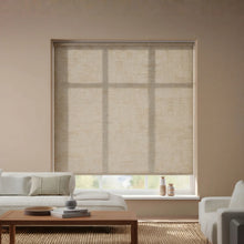 Load image into Gallery viewer, A stylish installation of Kyra Tan Sand Luxe natural light filtering roller shades, enhancing a modern interior space.
