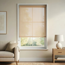 Load image into Gallery viewer, A Tan Sandstone Signature solar roller shade with 3% openness installed in a neutral living room, providing excellent UV protection and glare reduction while maintaining a soft filtered light.
