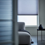 A look at Light Blue (Royal Grey) 7 16 Inch Double Cell Light Filtering Shades inside a peaceful living space, protecting furniture from fading while maintaining a bright feel.