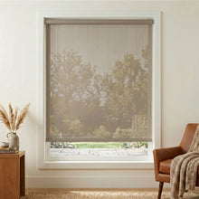 Load image into Gallery viewer, Premier 5% Solar Screen Roller Shade in light brown provides UV protection and filtered sunlight for a cozy reading nook or relaxation area.

