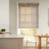 Light brown Toffee Luxe woven wood-look light filtering roller shades providing a warm glow in a kitchen dining area.
