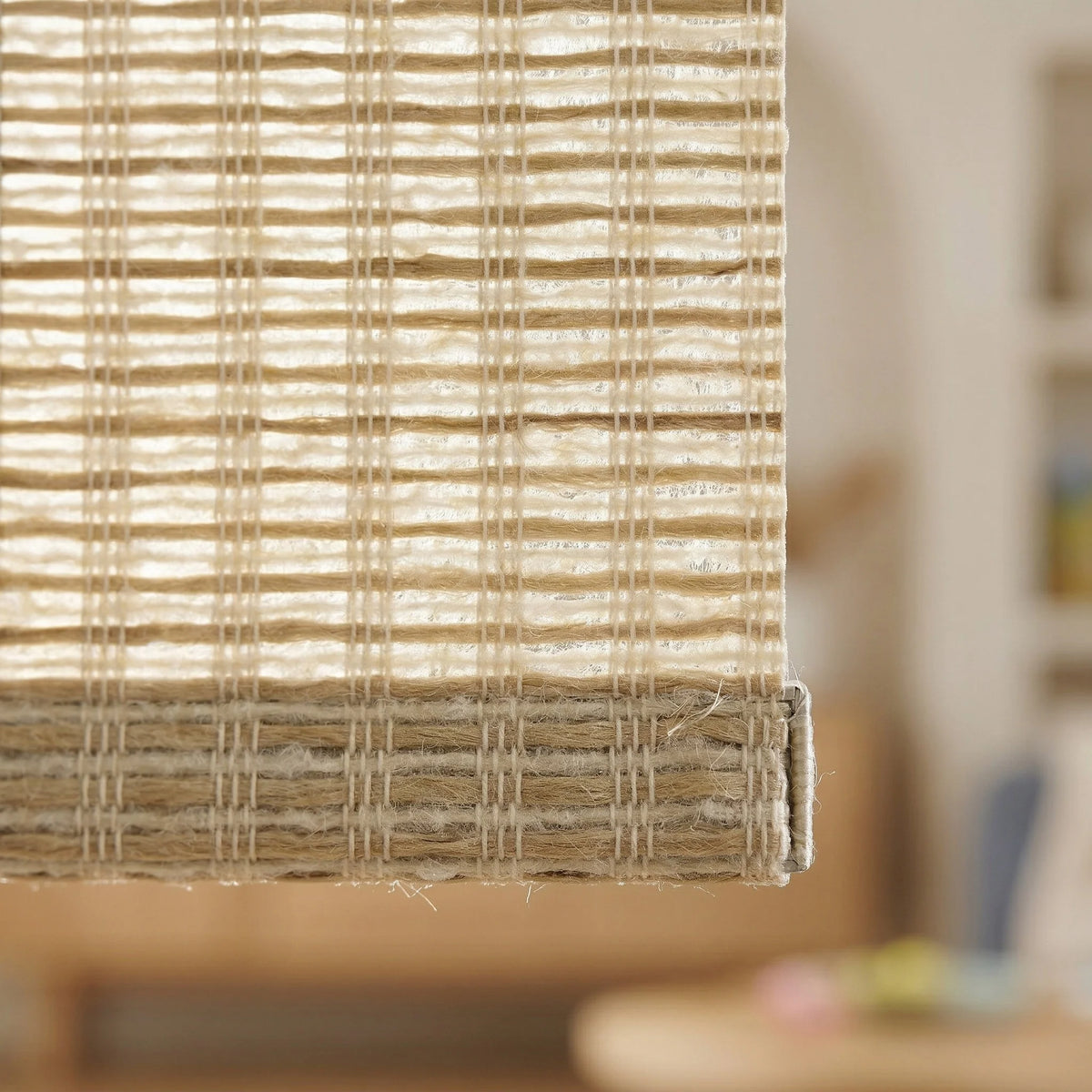 Detailed macro shot of the tan Natural Luxe woven wood-look light filtering roller shade texture, highlighting the technical decorative weave.