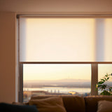 Off-white White Sand Luxe light filtering shades at sunset, showcasing the warm, diffused light effect.