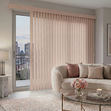 Load image into Gallery viewer, Custom window treatments: Soft Pink (Alyssa Sand) Premier Pvc Vertical Blinds shown in a serene living room, combining practical light filtering with a structured modern look.
