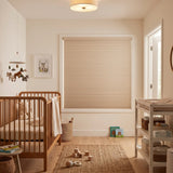 Tan French-Pastry Signature Blackout Single Cellular Shade on a bedroom window beside a mid-century nightstand