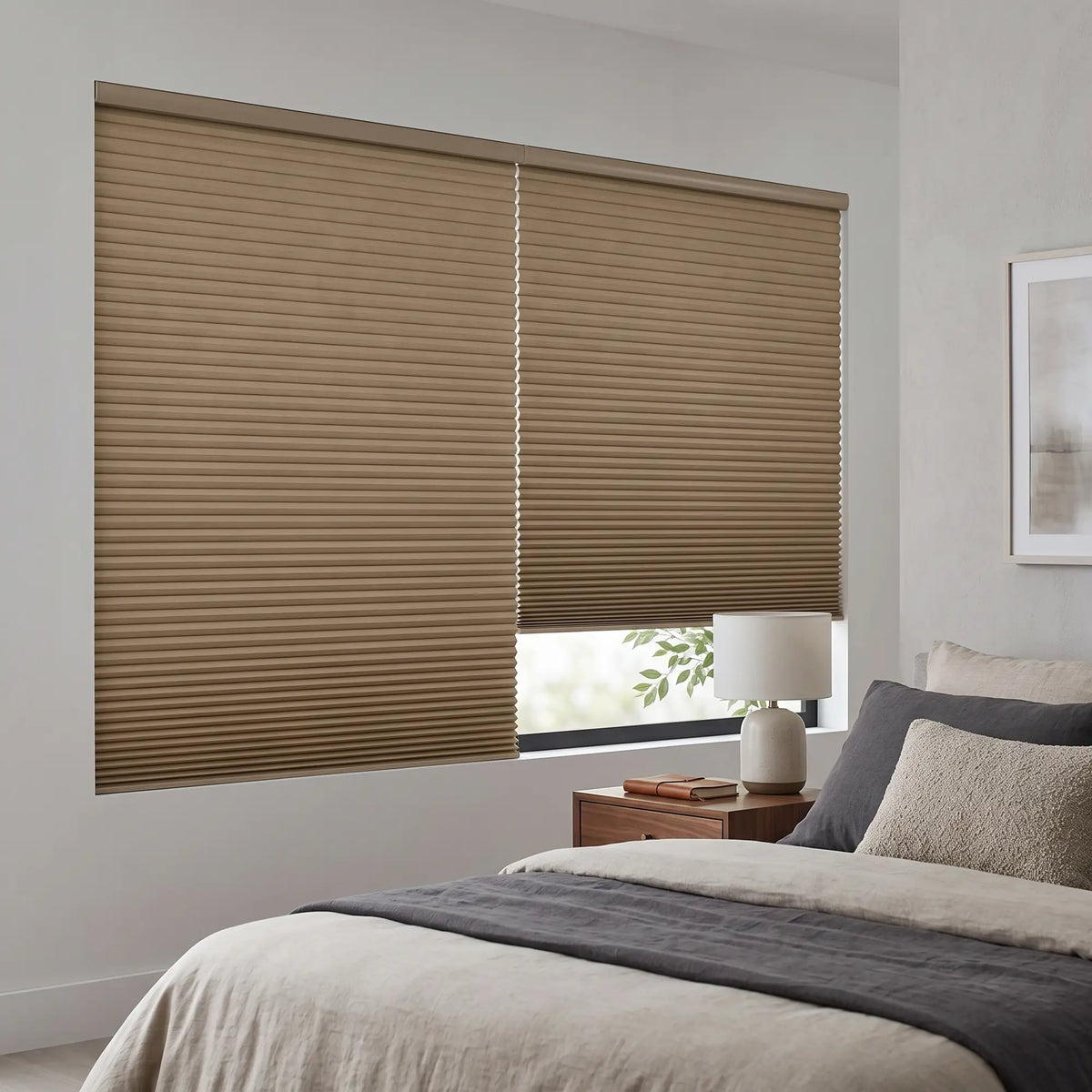 Tan Gingerroot Signature Blackout Single Cellular Shade on a bedroom window beside a mid-century nightstand