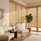 Hazel Natural Bamboo Shades warming a sunlit corner sunroom with two accent chairs