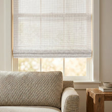 Load image into Gallery viewer, Illuminate your space with Cordless Woven Wood Shades, effortlessly filtering natural light with subtle Tan lines, creating a warm and inviting ambiance in this serene living room
