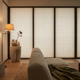 Tan Signature Blackout Single Cellular Shade on a sliding door in a spa-inspired living room