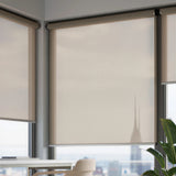 Taupe-gray Sandstone ProGrade solar shades with 5 percent openness in a contemporary high-rise office.