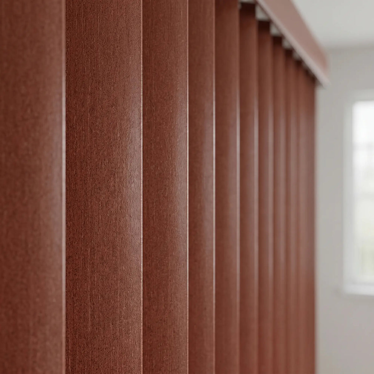 Woodtone Faux Wood PVC Vertical Blinds in Taupe subtly complement a plush sectional sofa, creating a warm and inviting living room ambiance.