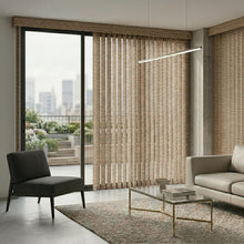 Load image into Gallery viewer, Signature Collection Fabric Vertical Blinds beautifully frame the outdoor patio, adding warmth and texture to this inviting living space with a gray chair, coffee table, and plush couch.
