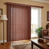 Woodtone Faux Wood PVC Vertical Blinds beautifully complement the brown tones of this inviting outdoor patio, effortlessly filtering natural light through a sliding glass door.