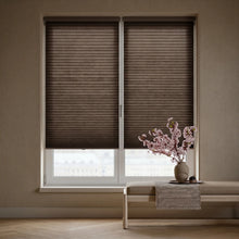 Load image into Gallery viewer, Warm Brown (Espresso) 3 8 Inch Budget Single Cell Light Filtering Cordless Shades installed in a cozy living room, providing excellent UV protection and a soft ambient light.
