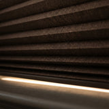 Styling a warm retreat with Warm Brown 1 2 Inch Budget Single Cell Blackout Cordless Shades, shielding the interior from bright daylight and street lamps.