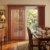 Woodtone Faux Wood PVC Vertical Blinds perfectly complement the rustic charm of this outdoor patio area, filtering sunlight for a warm and inviting ambiance.