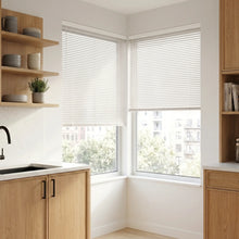 Load image into Gallery viewer, Custom window treatments: White (Almost Gloss White) Classic Cordless 6g Aluminum Mini Blinds shown in a cozy bedroom, delivering durable privacy with a modern metallic profile.
