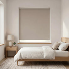 Load image into Gallery viewer, Economy Basic Vinyl Blackout Roller Shades in a crisp white finish, adding minimalist charm to a serene bedroom setting.

