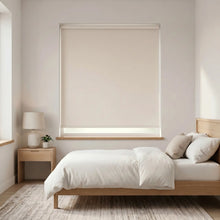 Load image into Gallery viewer, Economy Basic Vinyl Blackout Roller Shades in a serene bedroom setting, adding subtle elegance with its sleek white frames and functionality that dims ambient light for a cozy atmosphere.

