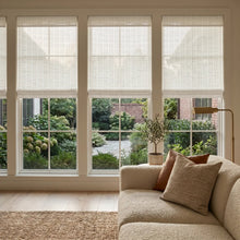 Load image into Gallery viewer, Cream Natural Bamboo Shades in soft white overlooking a garden courtyard
