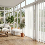 View of a serene living space with White Classic Curved Pvc Smooth Vertical Blinds, perfect for covering sliding glass doors or large windows.