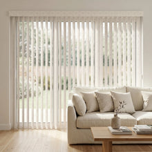 Load image into Gallery viewer, White (Joann Off White) Premier Pvc Vertical Blinds providing a structured touch to this inviting living room, allowing adjustable natural light through durable PVC vanes.
