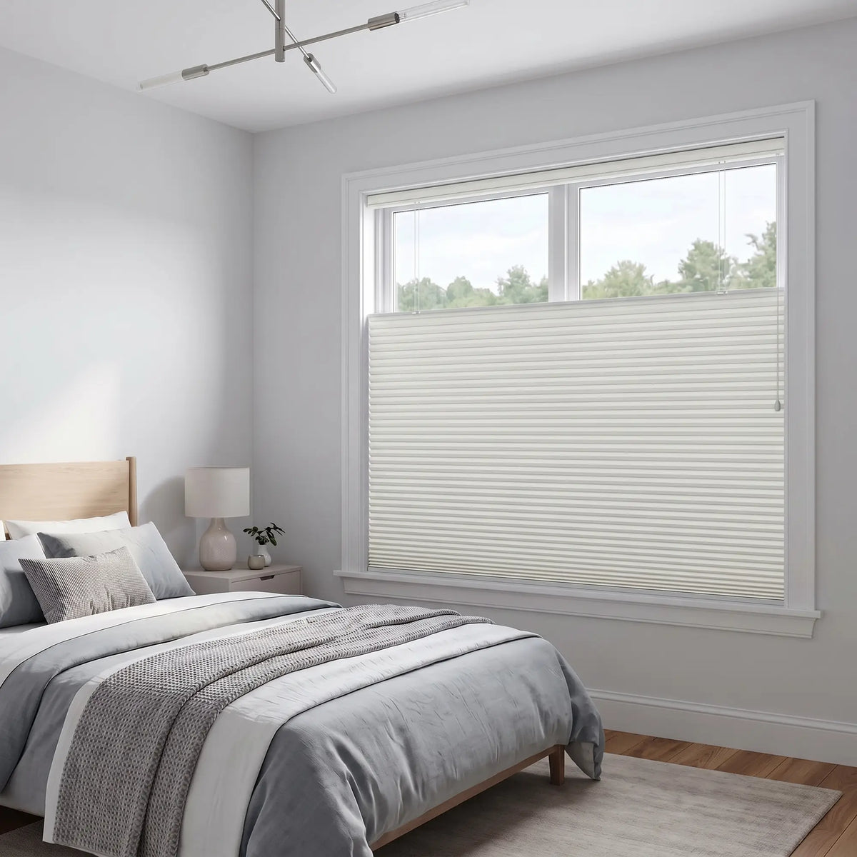 White Llama Signature Blackout Double Cellular Shade on a bedroom window beside a wood nightstand