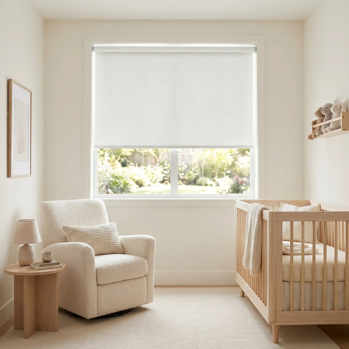 White Luxe fabric blackout roller shades installed in a bright nursery room with a wooden crib and glider, showcasing a light-blocking solution for daytime naps
