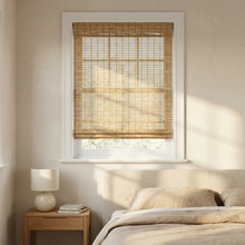 Load image into Gallery viewer, Cordless Woven Wood Shades made of natural bamboo add warmth and serenity to this peaceful bedroom oasis with a wooden headboard and plush pillows.
