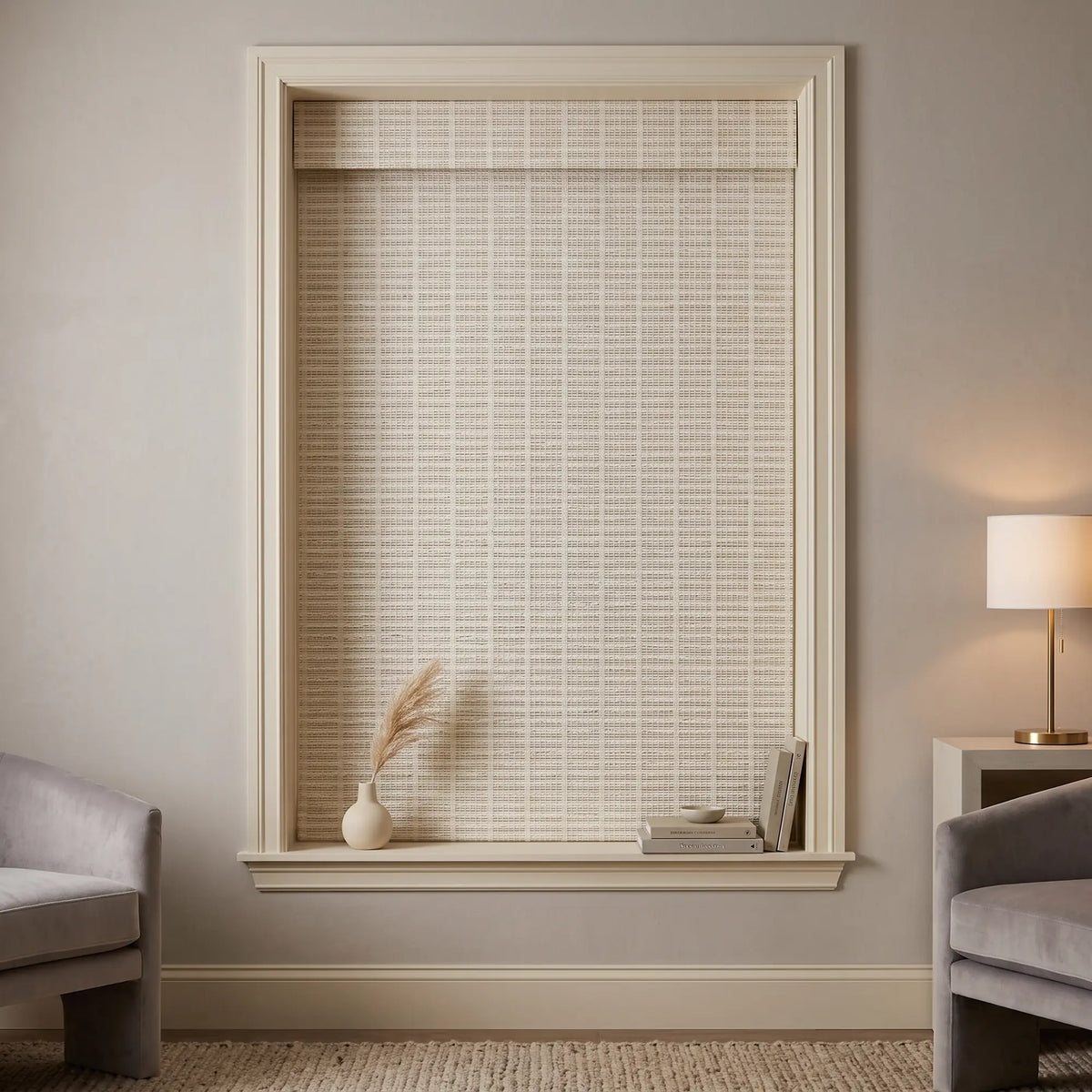 White woven Natural Bamboo Shade on a framed living room window in a cozy seating nook