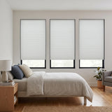White White-Radish Signature Blackout Double Cellular Shade on a bedroom window beside a wood nightstand