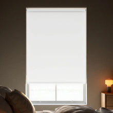 Load image into Gallery viewer, Close-up view of White Signature room darkening roller shades, showing the fabric texture and clean window fit.
