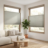 Simplistic Cordless Tdbu Pleated Shades in White elegantly filter sunlight, casting a serene ambiance amidst lush greenery and modern furnishings