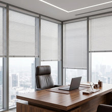 Load image into Gallery viewer, Interior view of a cozy living room styled with White (Snow Crystal) Classic Cordless 6g Aluminum Mini Blinds, offering lightweight yet sturdy window coverage.
