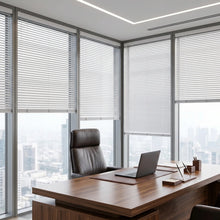 Load image into Gallery viewer, Custom window treatments: White (True White) Classic Cordless 6g Aluminum Mini Blinds shown in a cozy living room, ensuring a clean, cordless aesthetic and enhanced child safety.
