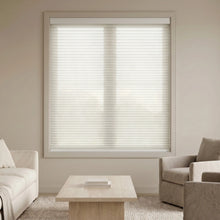 Load image into Gallery viewer, Winter White 9 16 Classic Single Cell Light Filtering Cordless Shades installed in a inviting living space, reducing screen glare while welcoming natural sunshine.
