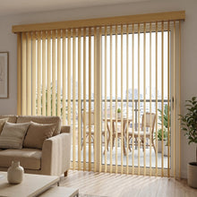 Load image into Gallery viewer, Warm wooden tones from Wood Grain Faux Wood PVC Vertical Blinds allow natural light and privacy in this inviting living room with plush sectional sofa
